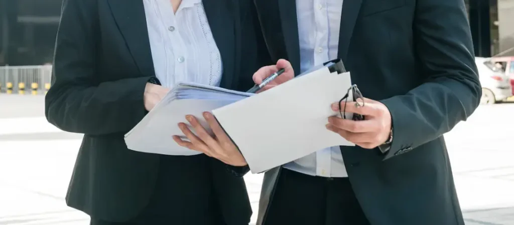 A certified property valuer reviewing documents outside a Melbourne property